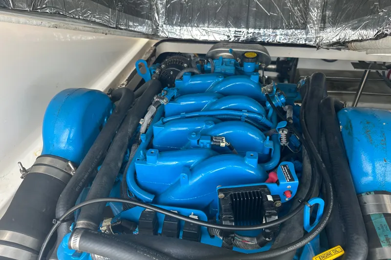 Slide: The Image of Engine compartment of a 2005 Tiara Yachts 2900 Coronet, featuring a blue marine engine. - 26