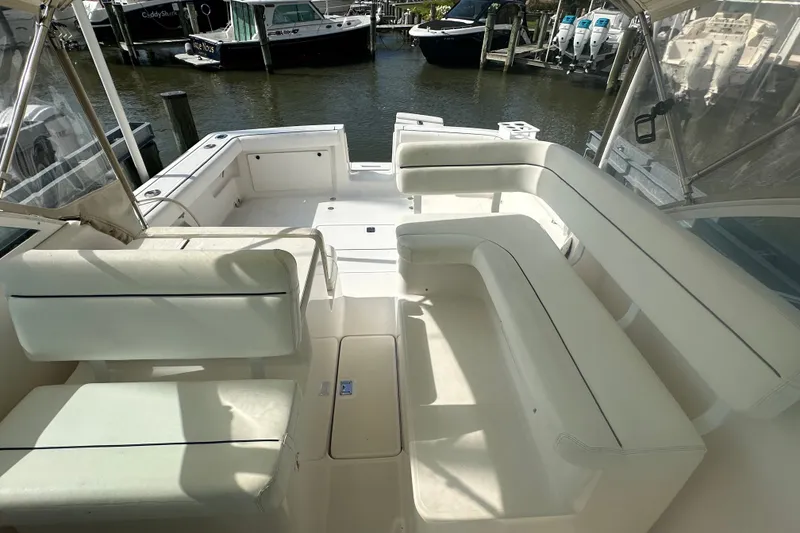 Slide: The Image of 2005 Tiara Yachts 2900 Coronet interior with white seating, docked at marina. - 10