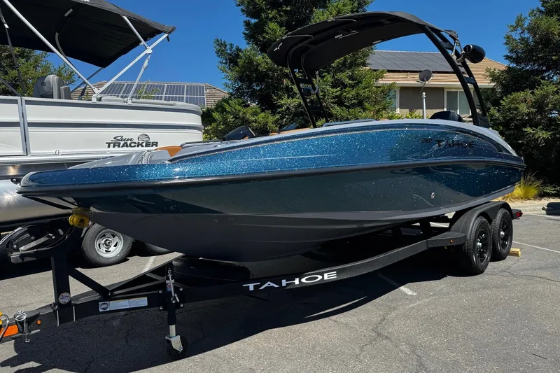 Slide: The Image of 2027 Tahoe 2150 boat on trailer, parked outdoors under clear sky. - 22