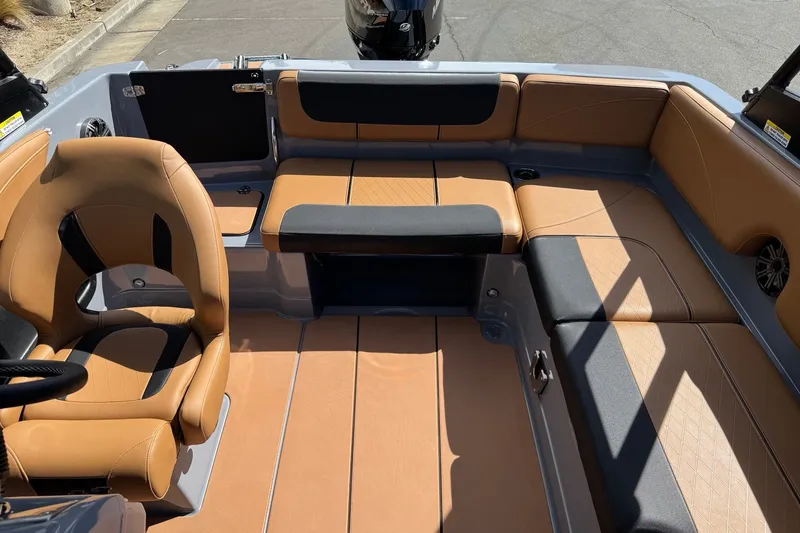 Slide: The Image of 2027 Tahoe 2150 boat interior with tan and black seating, featuring a comfortable captain's chair. - 7