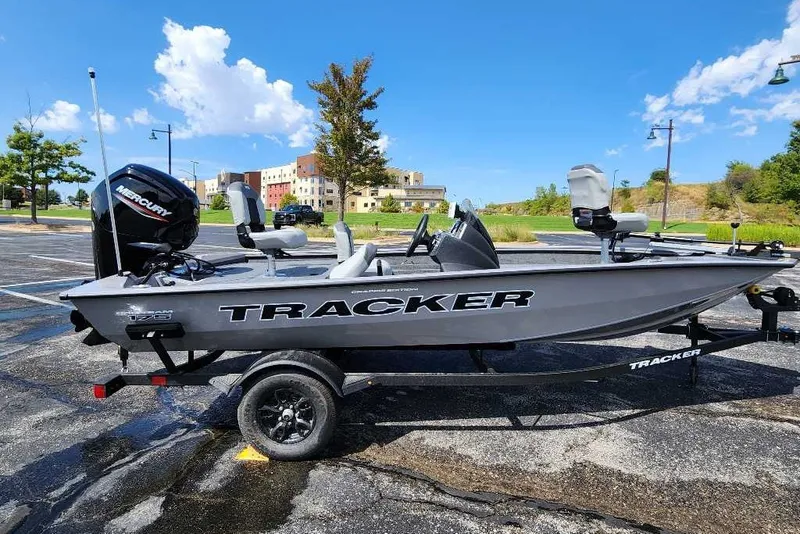 The Image of 2027 Tracker Pro Team 175 Crappie Edition boat on trailer, parked outdoors. - 0