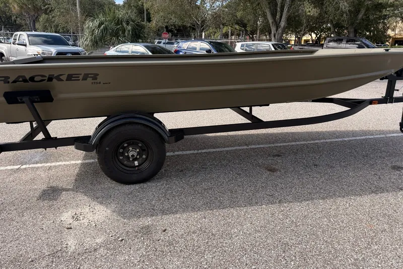The Image of 2027 Tracker Grizzly 1754 Utility boat on trailer in parking lot. - 0