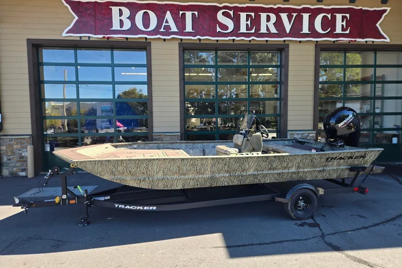 The Image of 2027 Tracker Grizzly 2072 CC boat on trailer outside service center. - 0