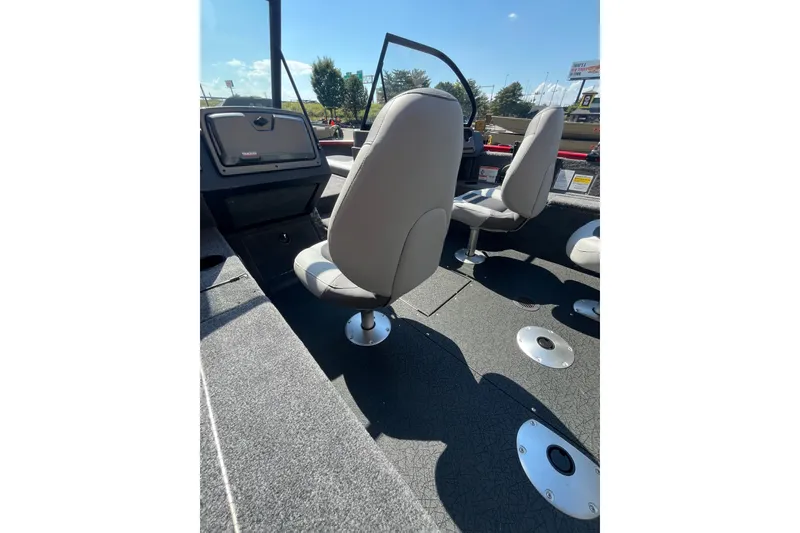 Slide: The Image of 2027 Tracker Pro Guide V-175 Combo boat interior with seating and dashboard view. - 54