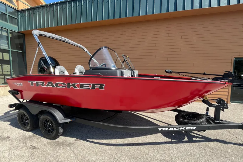 Slide: The Image of 2027 Tracker Pro Guide V-175 Combo boat in vibrant red on a trailer. - 55