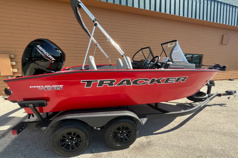 Slide: The Image of 2027 Tracker Pro Guide V-175 Combo boat in vibrant red on a trailer. - 56