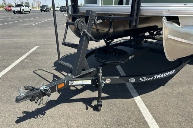 Slide: The Image of 2027 Sun Tracker Bass Buggy 16 XL Select trailer hitch in parking lot. - 76