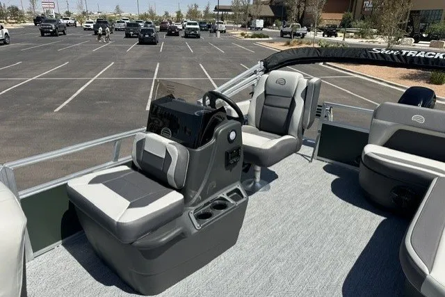 Slide: The Image of 2027 Sun Tracker Bass Buggy 16 XL Select pontoon boat interior with seating and steering console. - 15