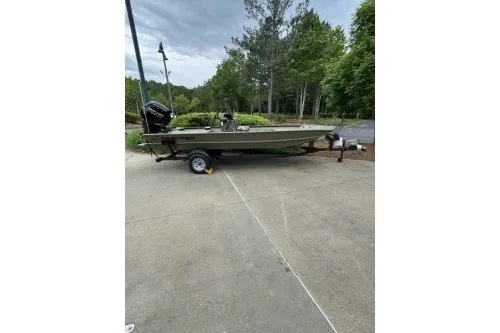 The Image of 2027 Tracker Grizzly 1860 CC boat on trailer, parked outdoors on concrete. - 0