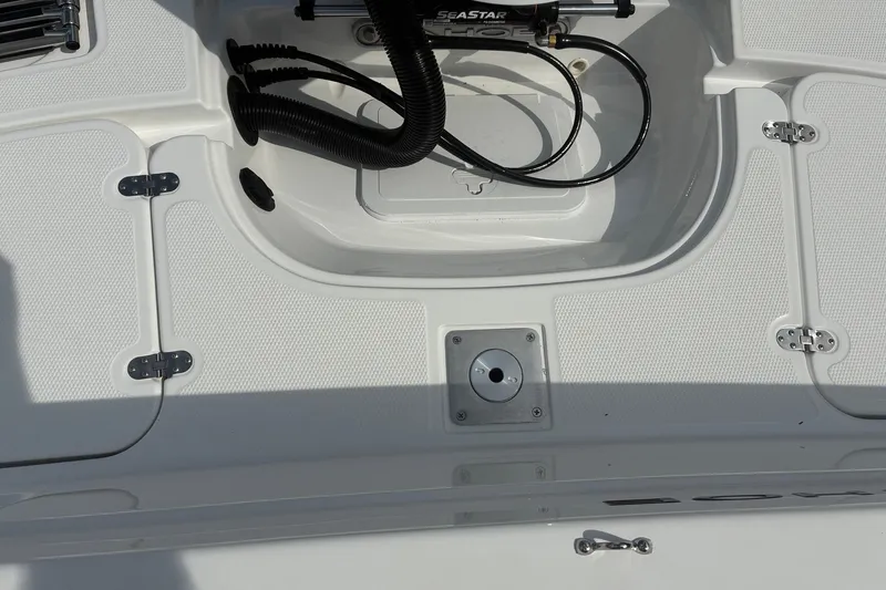Slide: The Image of Tahoe 2150 CC 2027 boat deck with storage compartments and hydraulic system. - 13