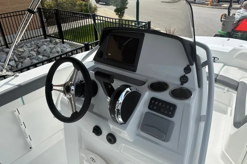 Slide: The Image of 2027 Tahoe 2150 CC boat dashboard with steering wheel and control panel. - 7