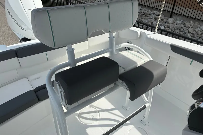 Slide: The Image of 2027 Tahoe 2150 CC boat interior with cushioned seating and Mercury engine. - 11