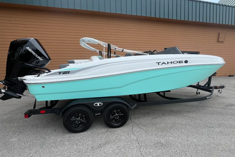 The Image of 2027 Tahoe T21 boat with Mercury engine on trailer, parked outdoors. - 0
