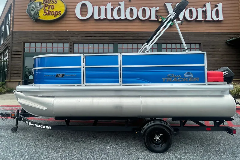 The Image of 2027 Sun Tracker Party Barge 16 DLX pontoon boat outside Bass Pro Shops. - 0