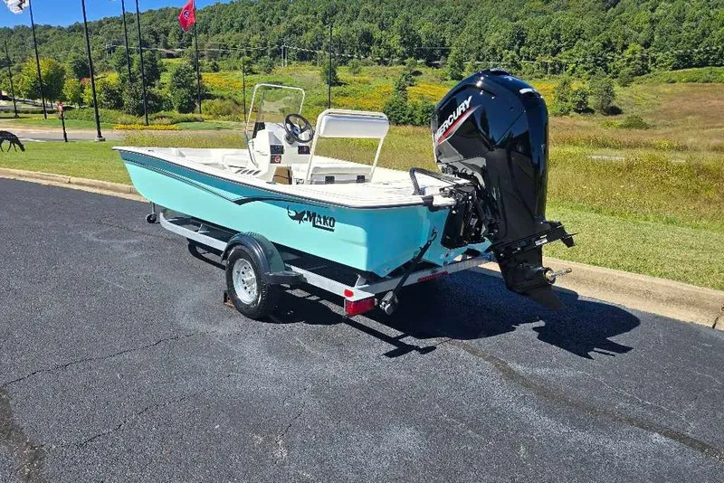 Slide: The Image of 2027 Mako Pro Skiff 17 CC boat on trailer, parked outdoors. - 3