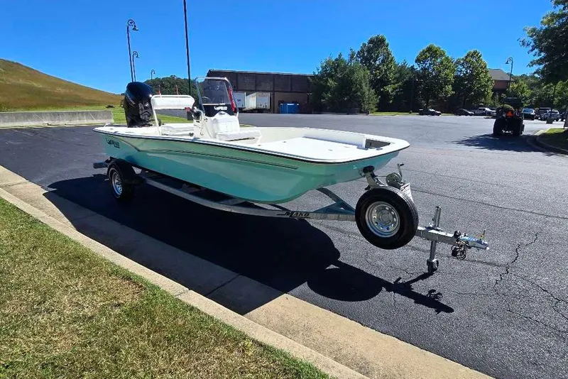 Slide: The Image of 2027 Mako Pro Skiff 17 CC boat on trailer in sunny parking lot. - 9