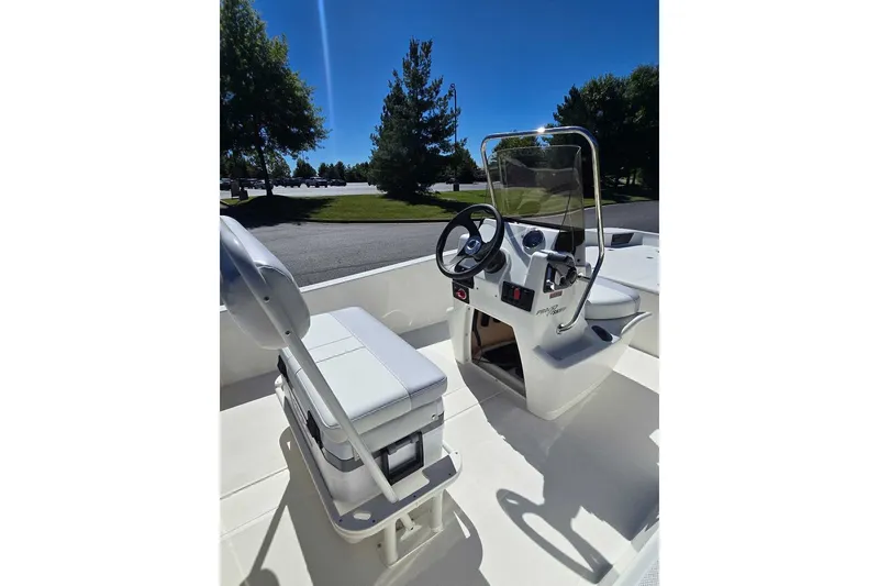 Slide: The Image of 2027 Mako Pro Skiff 17 CC boat interior with steering console and seating. - 6