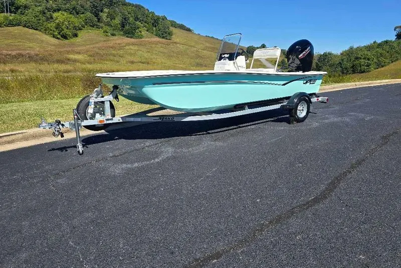 The Image of 2027 Mako Pro Skiff 17 CC boat on trailer, parked on asphalt road. - 0