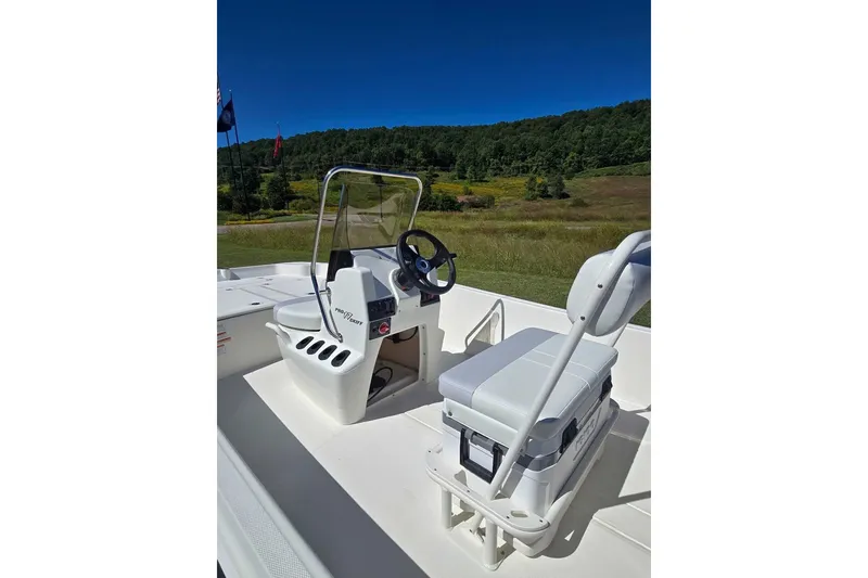 Slide: The Image of 2027 Mako Pro Skiff 17 CC boat interior with steering console and seating. - 7