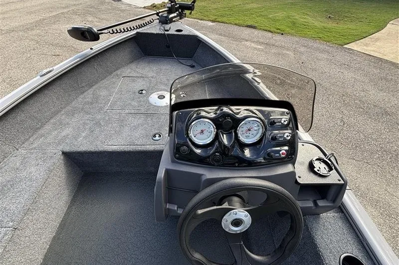 Slide: The Image of 2027 Tracker Super Guide V-16 SC boat dashboard with steering wheel and gauges. - 20