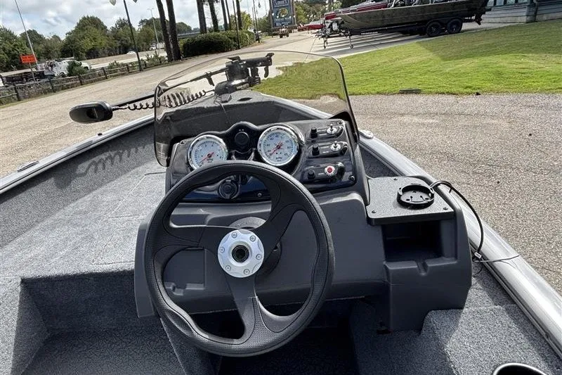 Slide: The Image of 2027 Tracker Super Guide V-16 SC boat dashboard with steering wheel and gauges. - 22