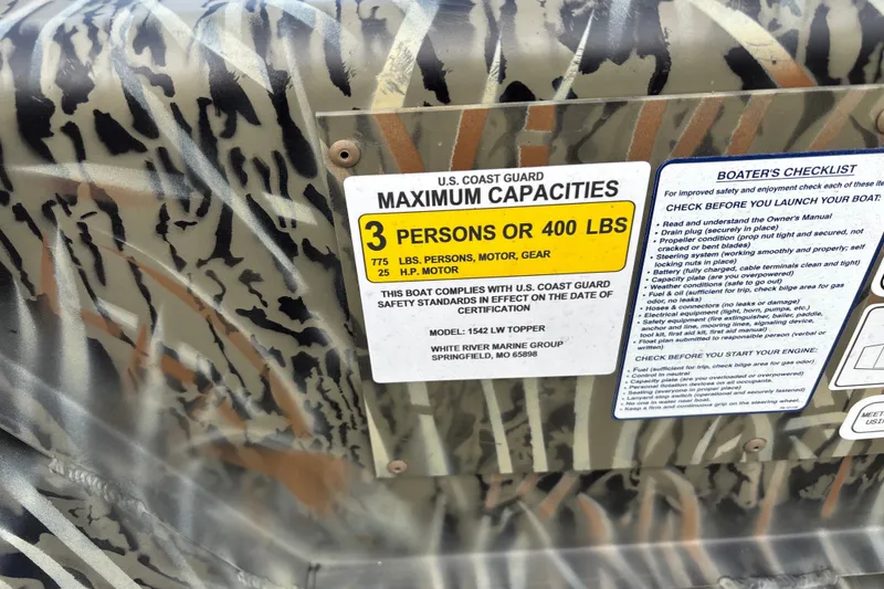 Slide: The Image of 2027 Tracker Grizzly 15 Jon boat capacity label, detailing maximum load and safety checklist. - 14