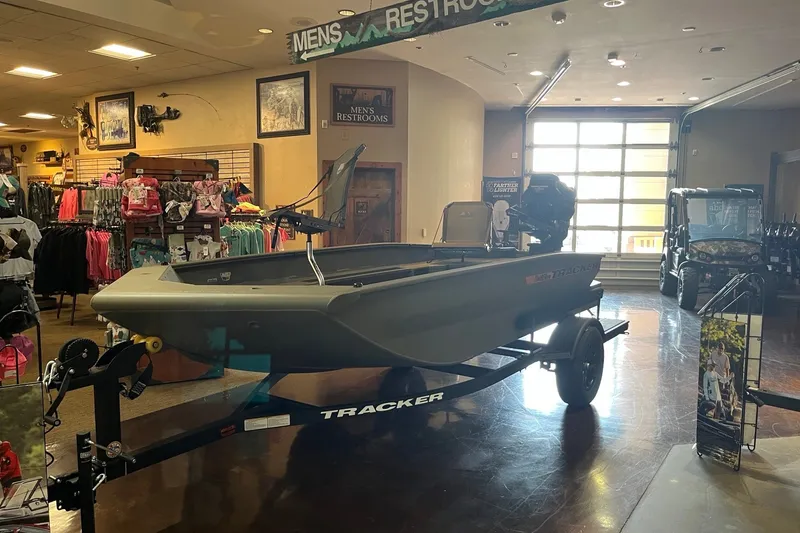 The Image of 2027 Tracker Grizzly 1553 Timber boat displayed indoors at a retail store. - 0