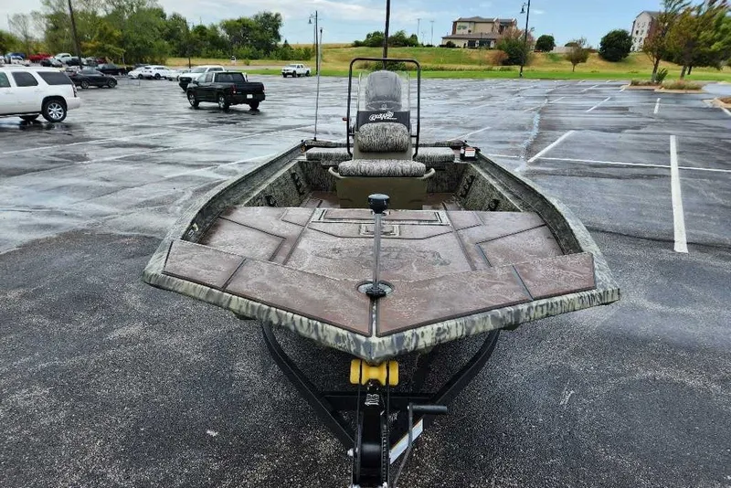 Slide: The Image of 2027 Tracker Grizzly 1860 CC boat in a parking lot, showcasing its front deck and seating. - 69
