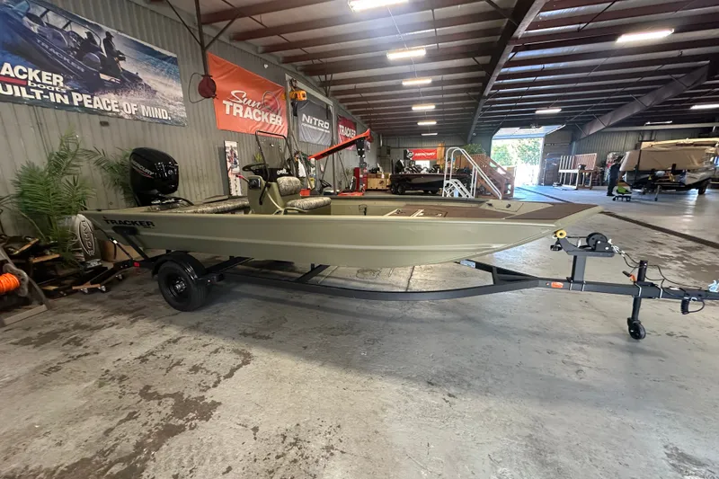 The Image of 2027 Tracker Grizzly 1860 CC boat on trailer in showroom setting. - 0