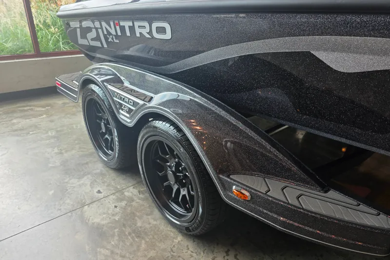 Slide: The Image of 2027 Nitro Z21 XL Pro boat trailer with sleek black wheels and metallic finish. - 5