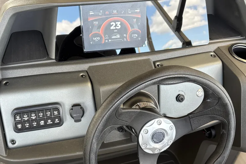 Slide: The Image of Dashboard of 2027 Sun Tracker Party Barge 18 DLX with digital display and steering wheel. - 25