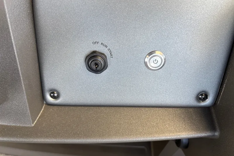 Slide: The Image of Control panel of 2027 Sun Tracker Party Barge 18 DLX with ignition and power button. - 27