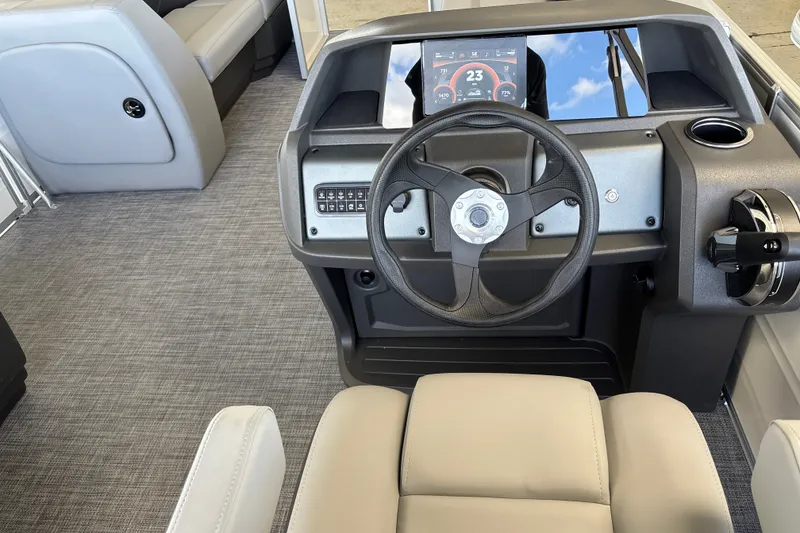 Slide: The Image of Interior view of 2027 Sun Tracker Party Barge 18 DLX boat dashboard and steering wheel. - 23