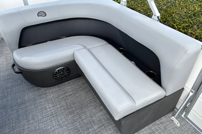 Slide: The Image of Luxurious seating on 2027 Sun Tracker Party Barge 18 DLX pontoon boat, featuring cup holders and speaker. - 13