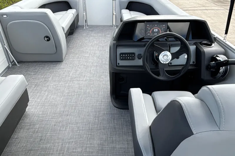 Slide: The Image of 2027 Sun Tracker Party Barge 18 DLX interior with modern helm and seating. - 22