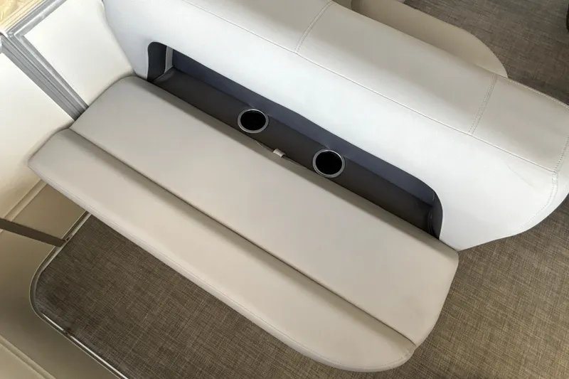 Slide: The Image of 2027 Sun Tracker Party Barge 18 DLX interior seating with cup holders, beige upholstery. - 20