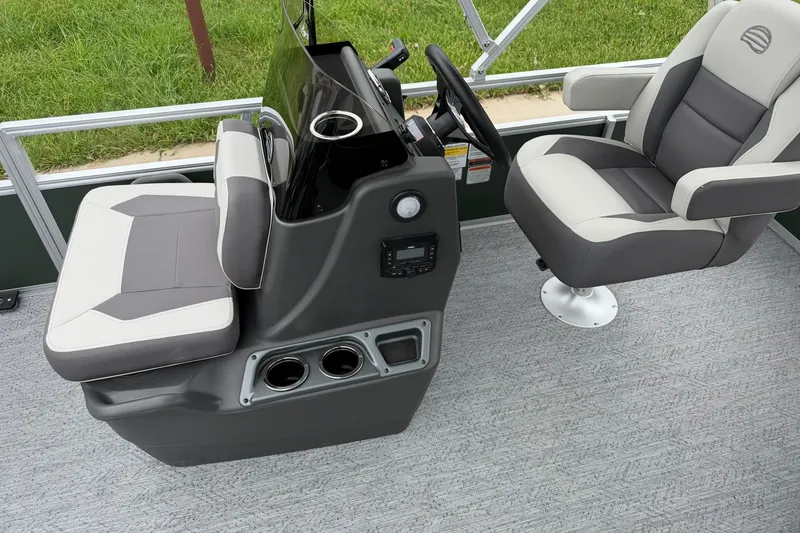 Slide: The Image of 2027 Sun Tracker Bass Buggy 16 XL Select boat interior with steering console and seating. - 16