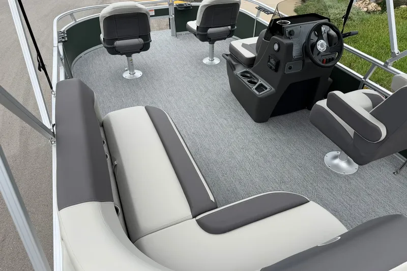 Slide: The Image of 2027 Sun Tracker Bass Buggy 16 XL Select pontoon boat interior with seating and steering console. - 22