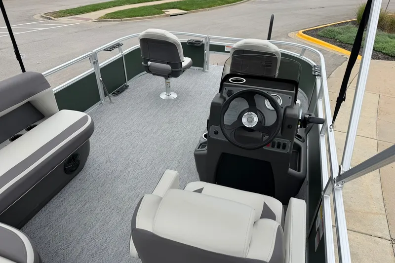 Slide: The Image of 2027 Sun Tracker Bass Buggy 16 XL Select pontoon boat interior with steering console and seating. - 21