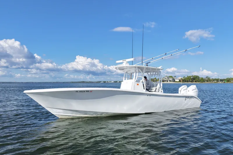 Slide: The Image of 2014 Yellowfin 32 Offshore boat on calm water under blue sky. - 22