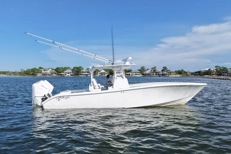 Slide: The Image of 2014 Yellowfin 32 Offshore boat on calm water, clear sky background. - 15