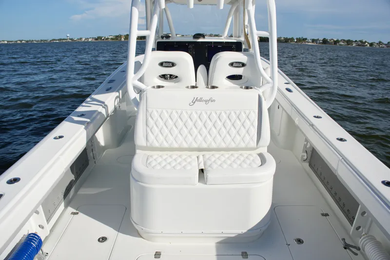 Slide: The Image of 2014 Yellowfin 32 Offshore boat with white seating, on calm waters. - 53