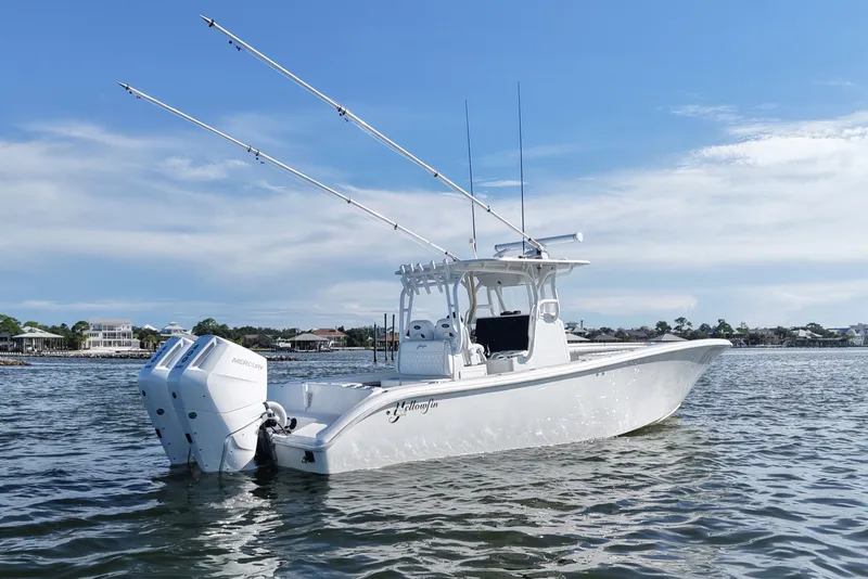 Slide: The Image of 2014 Yellowfin 32 Offshore boat on water with dual Mercury engines. - 16
