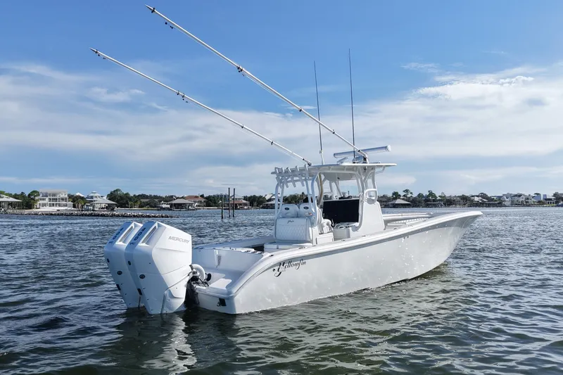 Slide: The Image of 2014 Yellowfin 32 Offshore boat with dual Mercury engines on calm water. - 17