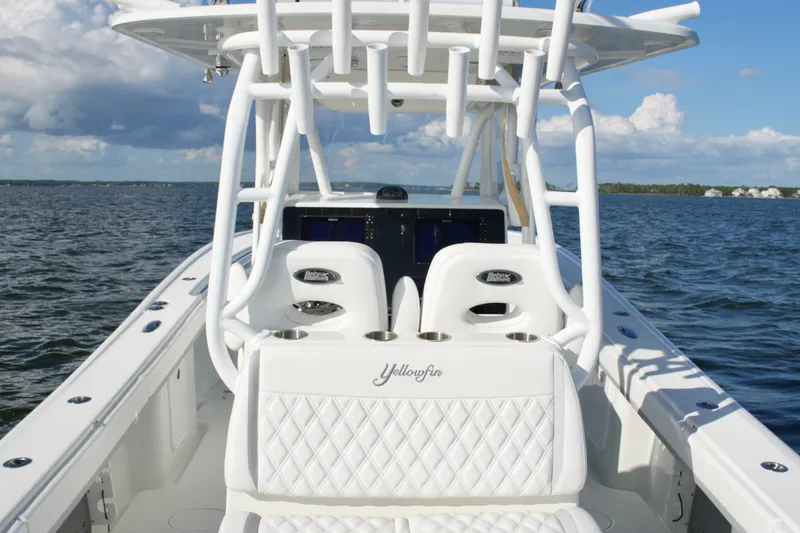 Slide: The Image of 2014 Yellowfin 32 Offshore boat with white seating on open water. - 35