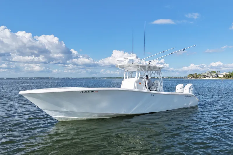 Slide: The Image of 2014 Yellowfin 32 Offshore boat on calm water under blue sky. - 21