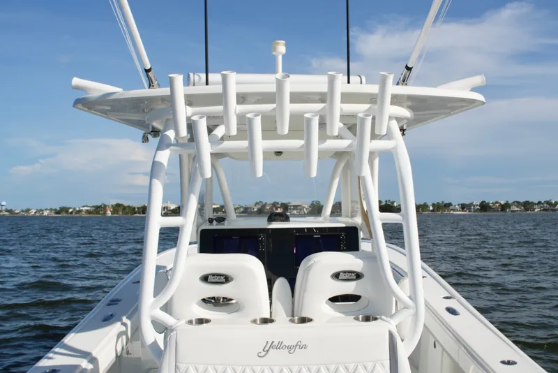Slide: The Image of 2014 Yellowfin 32 Offshore boat with rod holders, on calm water under blue sky. - 55