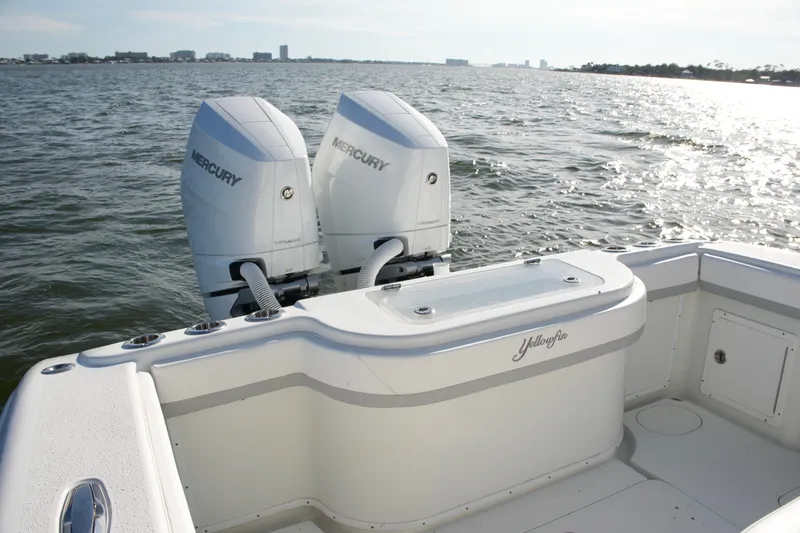 Slide: The Image of 2014 Yellowfin 32 Offshore boat with twin Mercury engines on open water. - 25