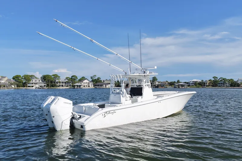 Slide: The Image of 2014 Yellowfin 32 Offshore boat on calm water, featuring dual Mercury engines. - 19