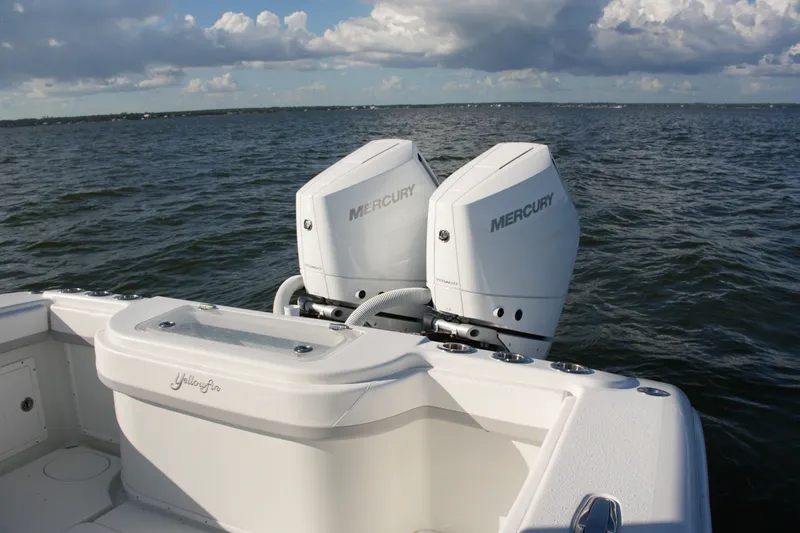 Slide: The Image of 2014 Yellowfin 32 Offshore boat with dual Mercury engines on open water. - 28